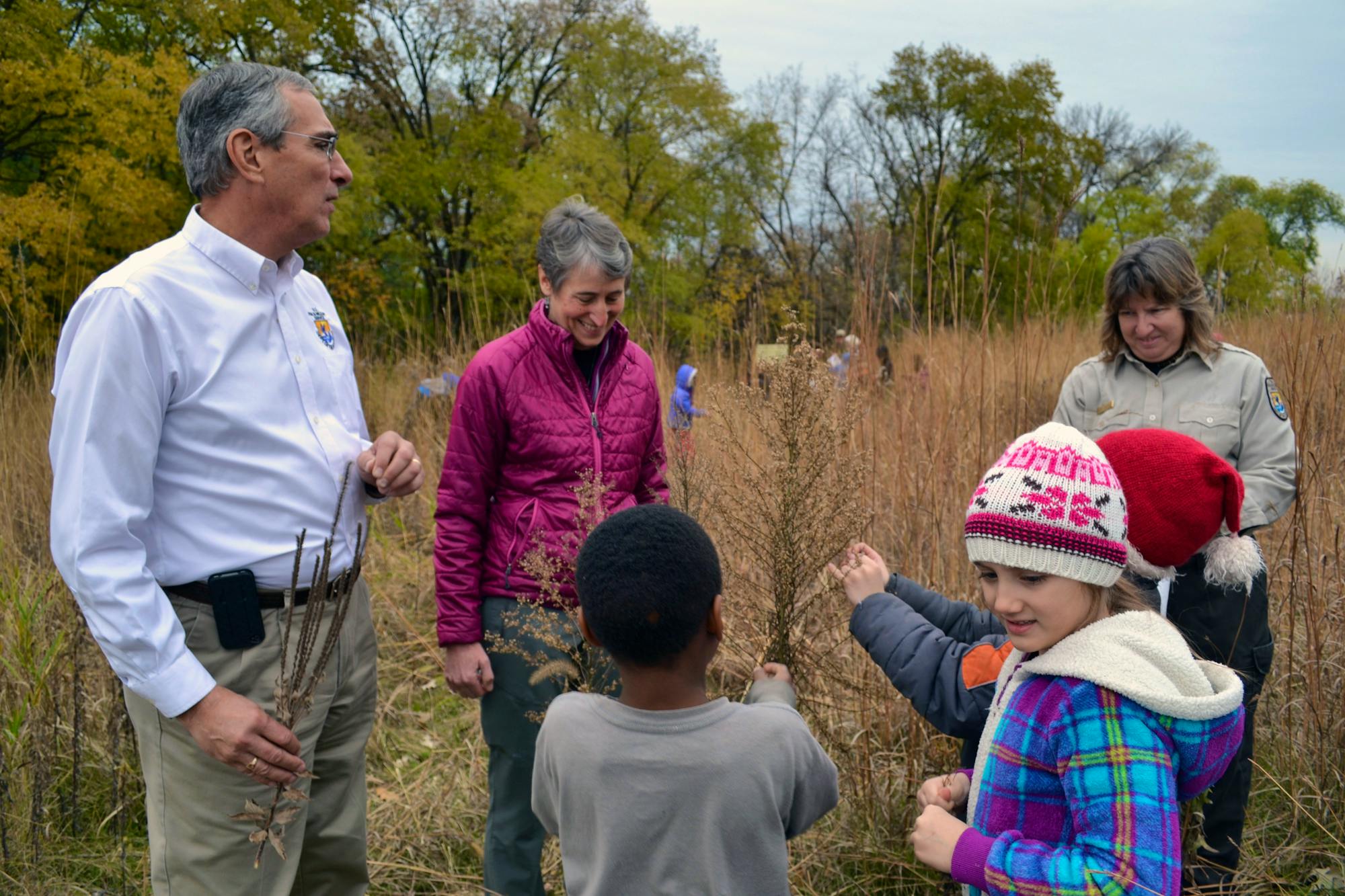 Secretary Sally Jewell and Regional Director Tom Melius help Minneapolis second graders collect native prairie seeds during her visit to Minnesota Valley National Wildlife Refuge 