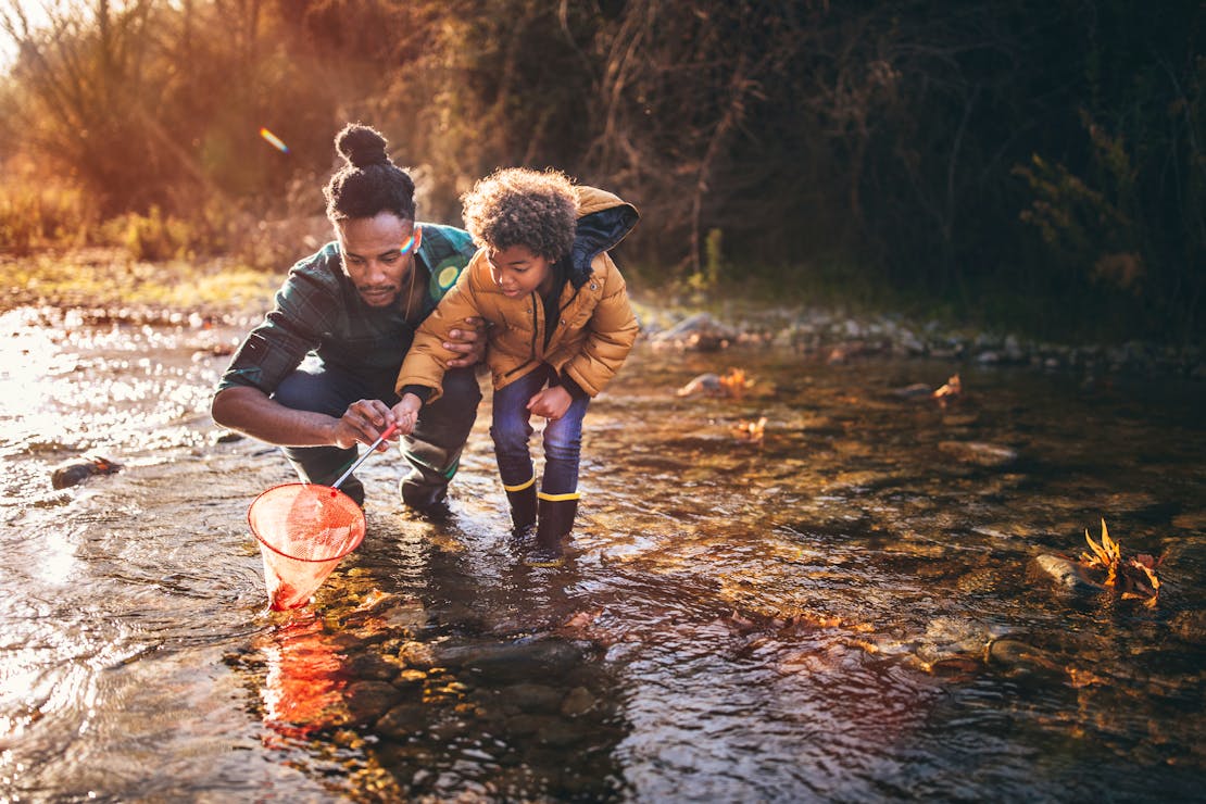 Father and son fishing in a river
