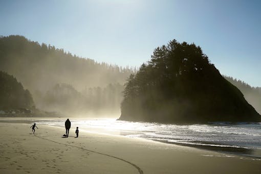 Oregon coast with family walking along beach