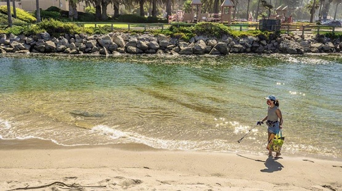 Cristina cleaning up a beach