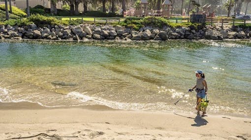 Cristina cleaning up a beach