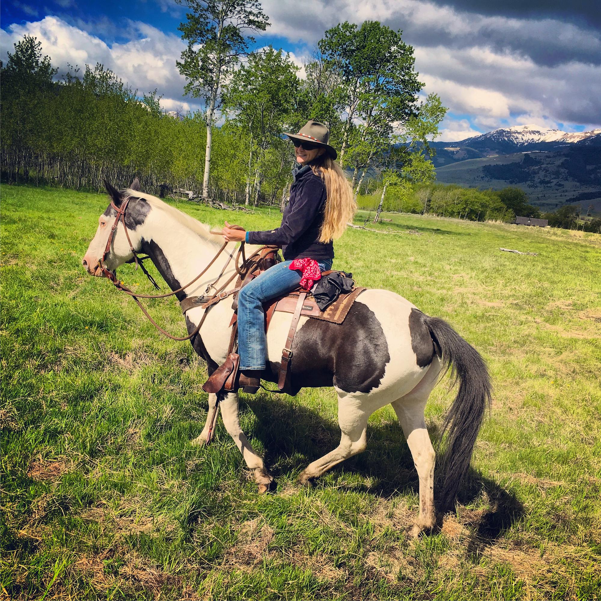 Pam riding horse during range rider workshop