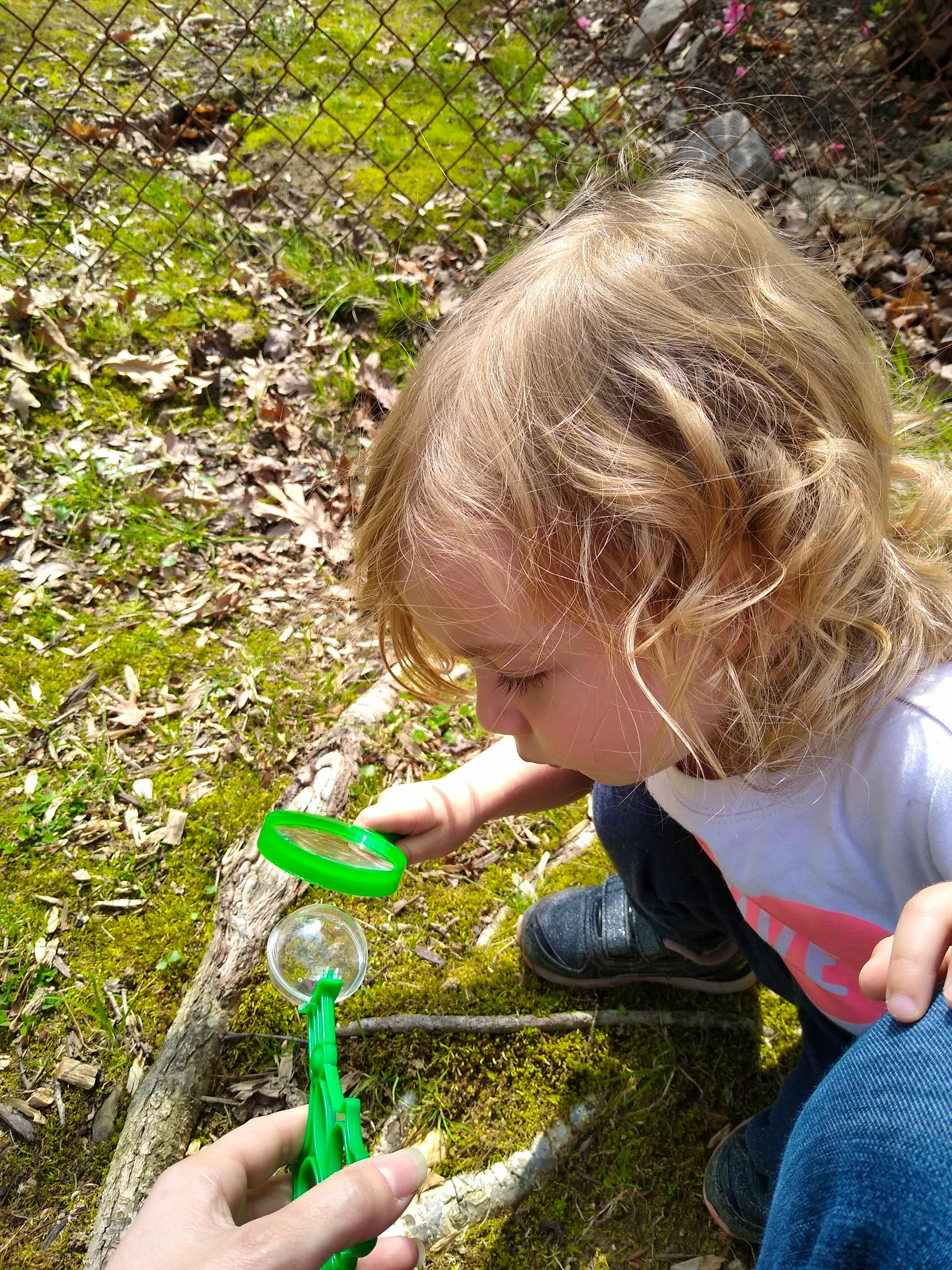 Girl using magnifying glass