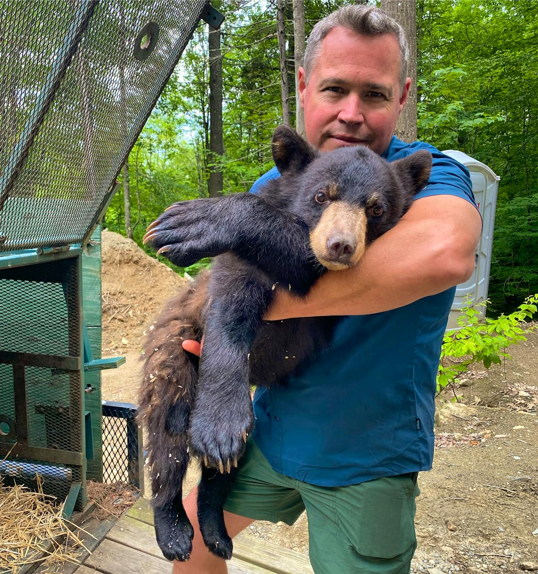 Jeff Corwin holding a black bear cub