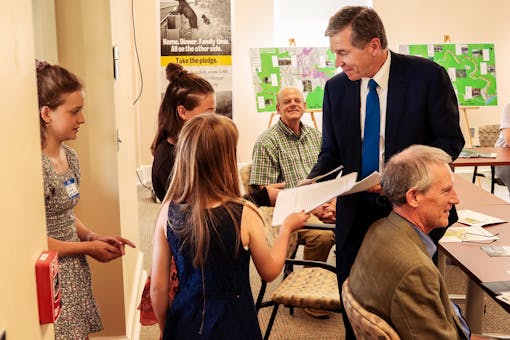 The students present their letters, and those from classmates, to Gov. Cooper.