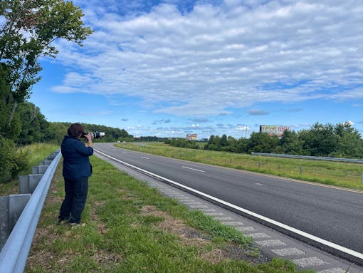 Jessie Williams, volunteer, photographing Watch for Wildlife Sign - Alligator River National Wildlife Refuge - North Carolina