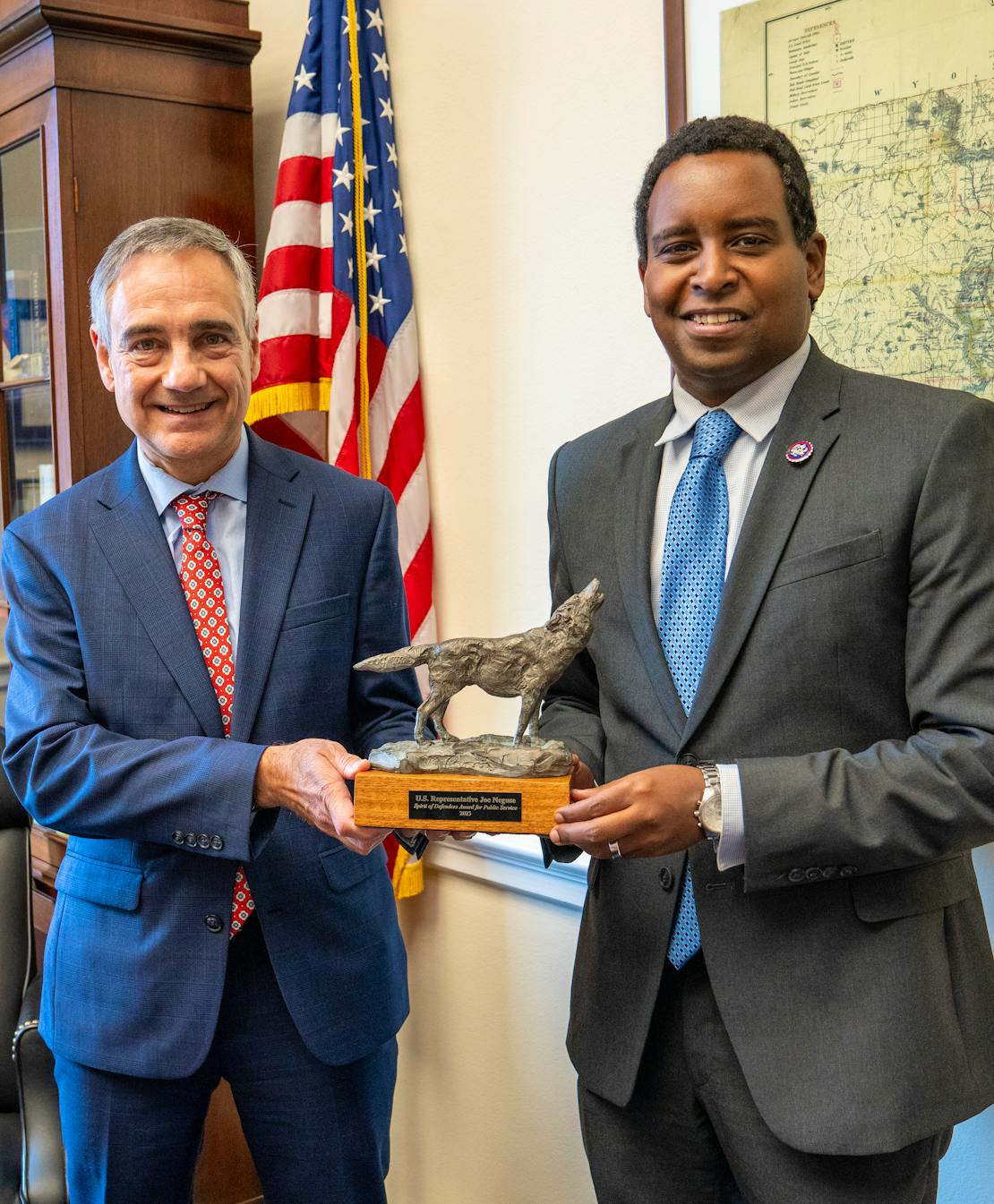 Robert Dewey, VP of Government Relations for Defenders of Wildlife presents Rep. Joe Neguse with the Spirit of Defenders award