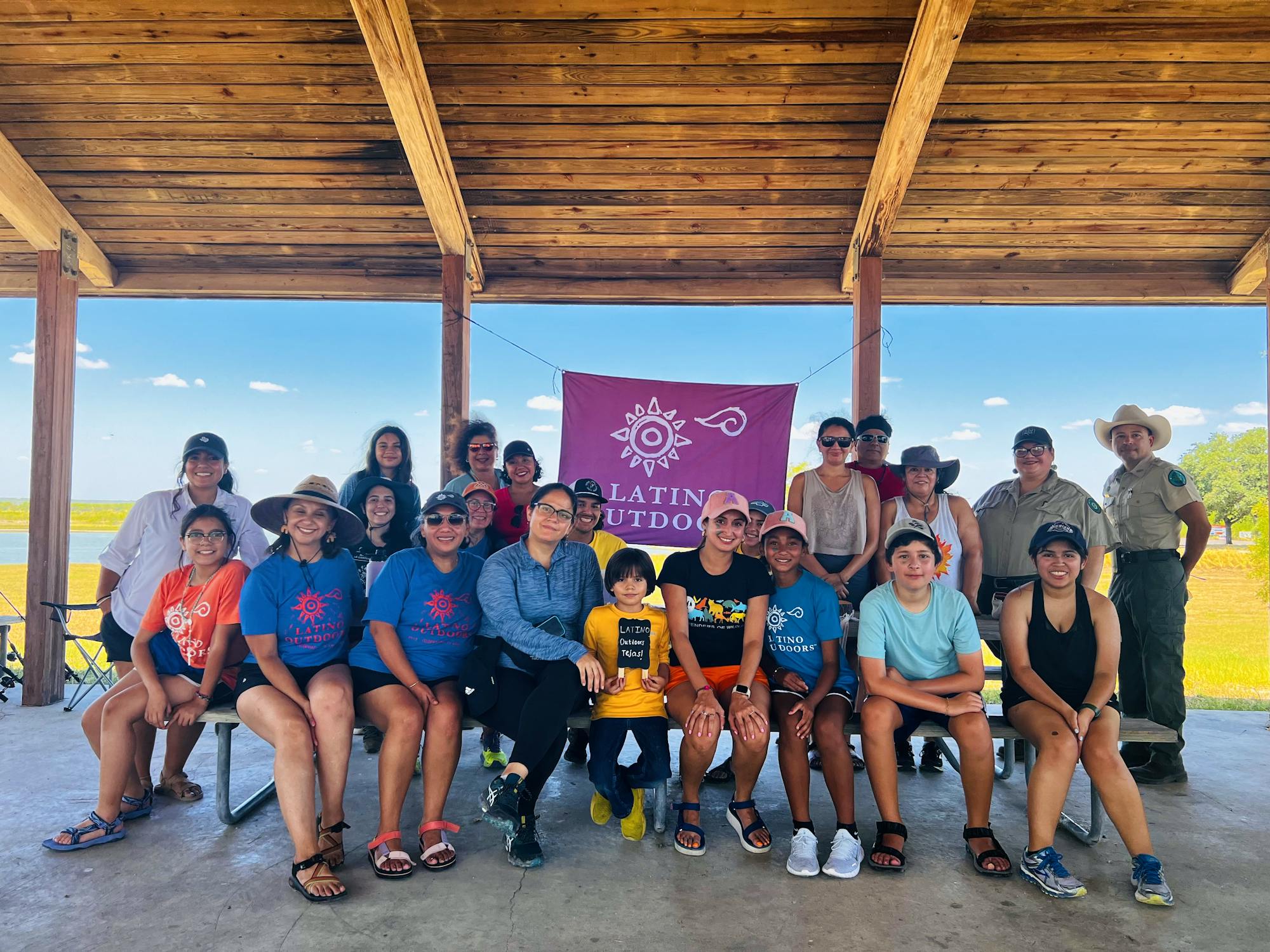 20230724 - SW - LCW - Group shot with Latino Outdoors sign in background_Azalia Rodriguez/DOW