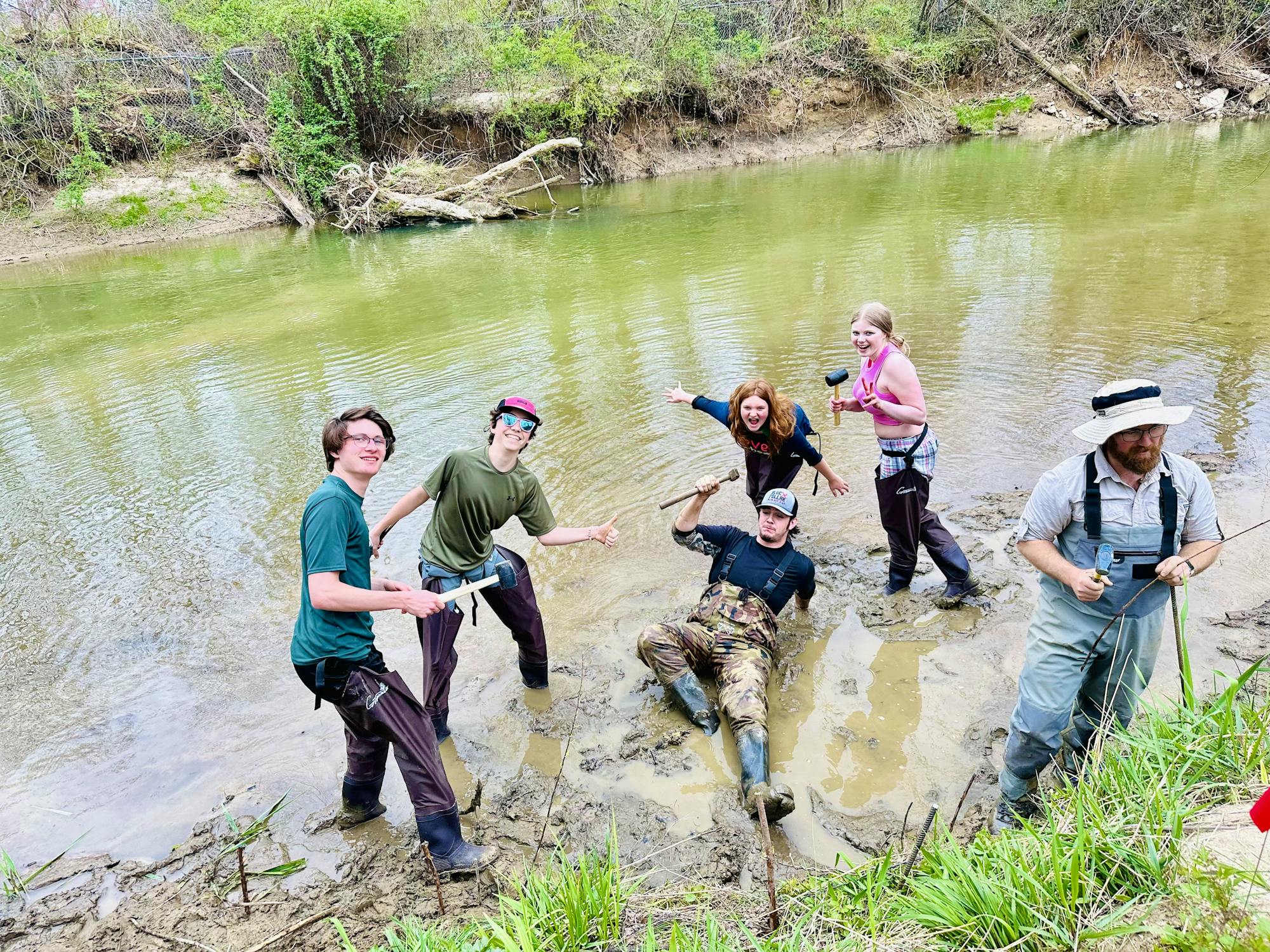 FernLeaf Community Charter School students take a spill while planting sapling trees.