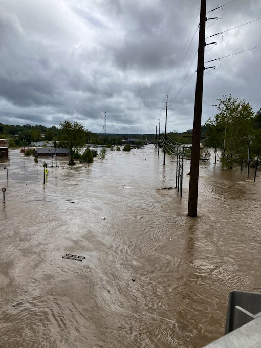 Streets flooded by the French Broad River in Asheville NC after Hurricane Helene hit