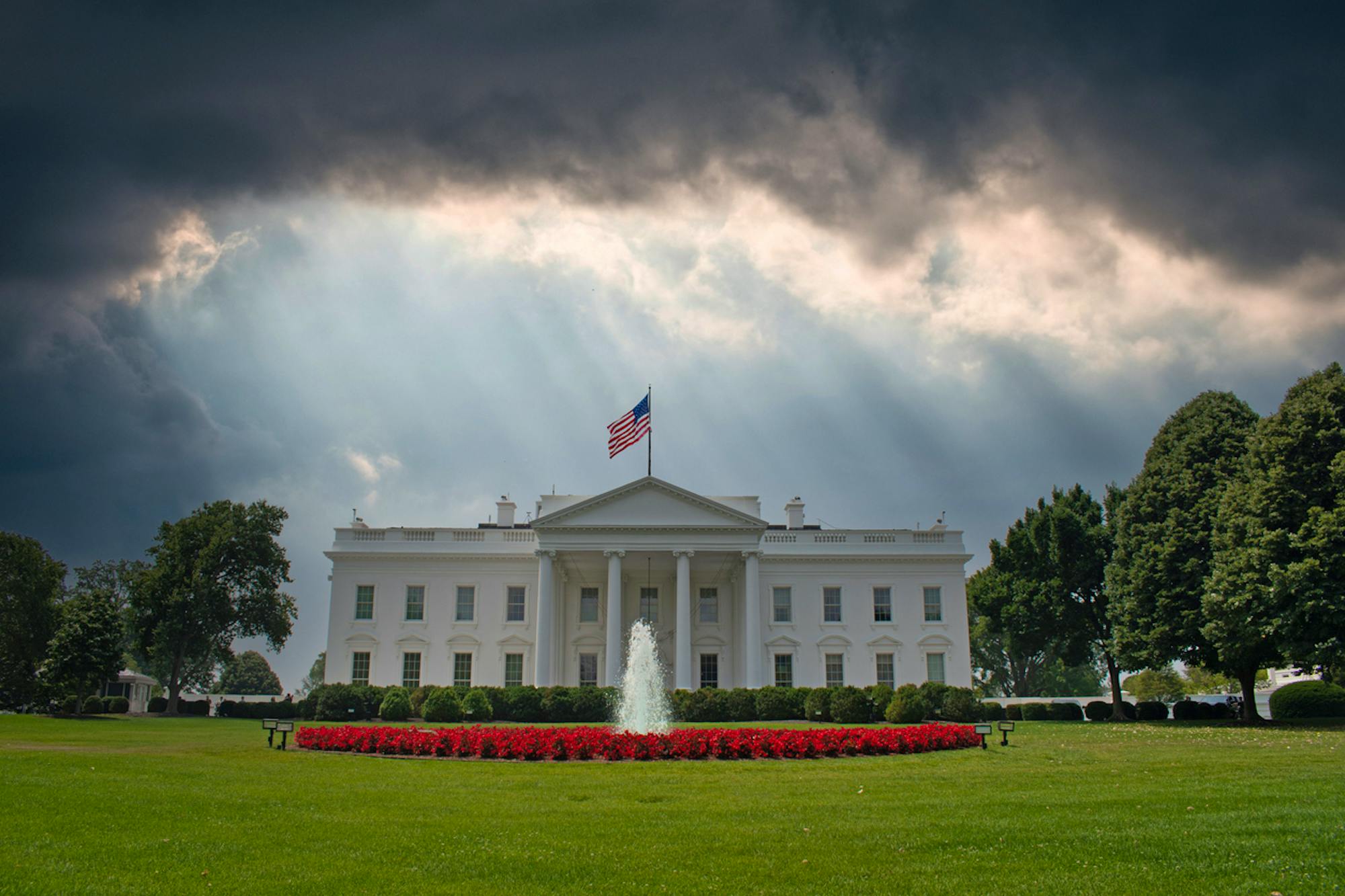 The White House with a dark cloudy sky