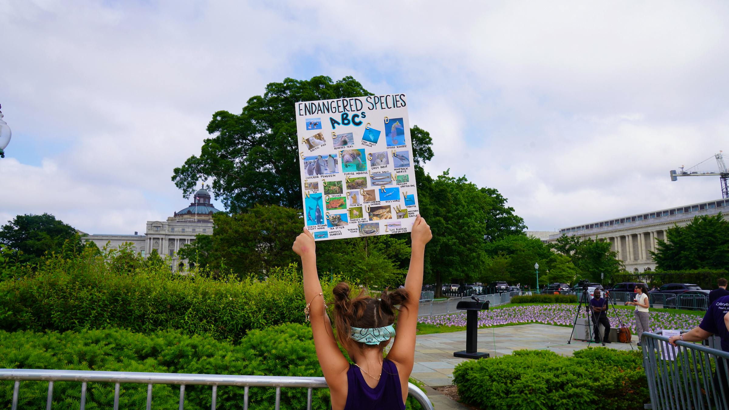 girl holding esa alphabet sign 