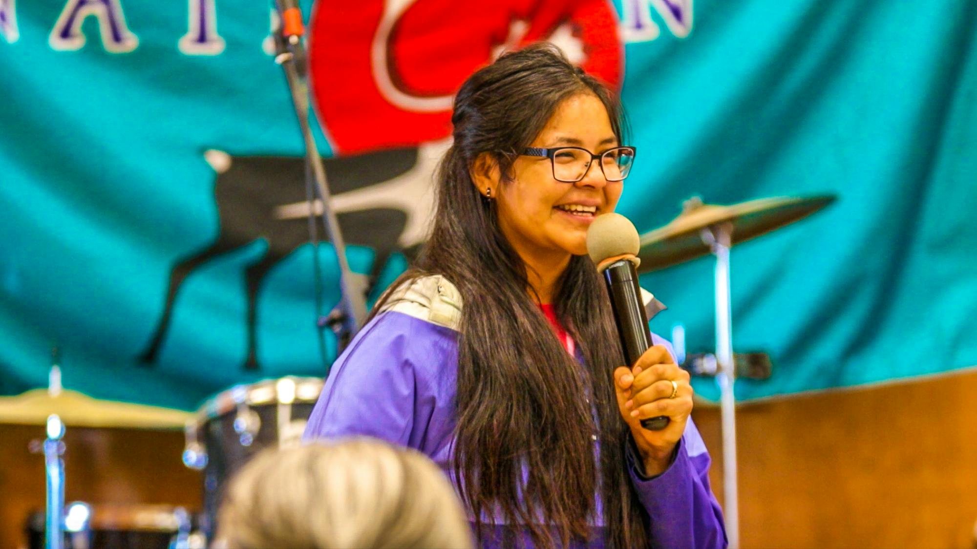 young activist speaking into microphone