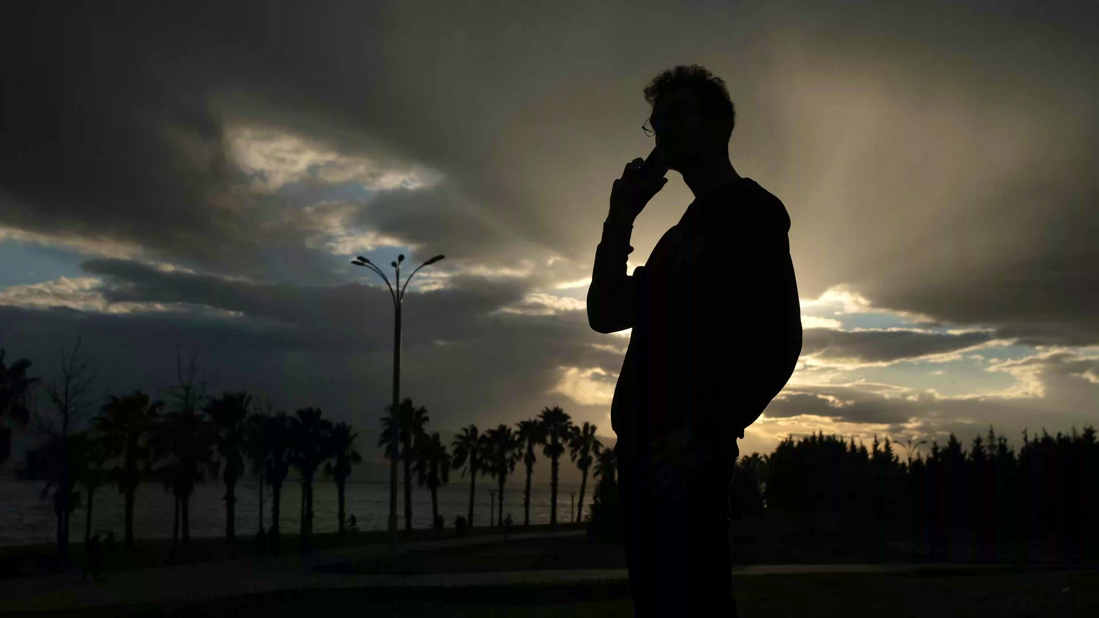 silhouette of person making a phone call