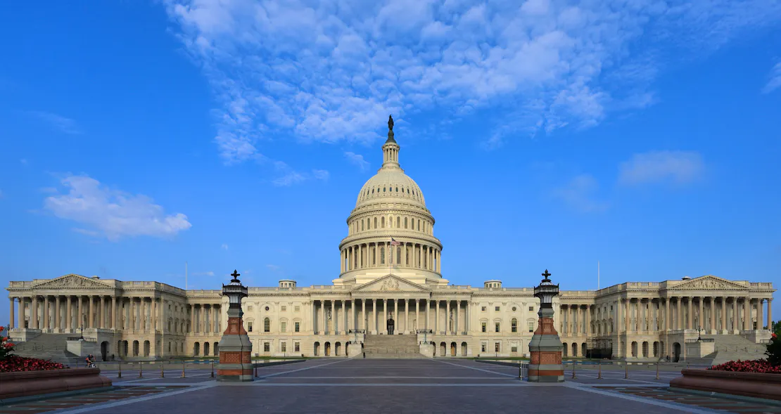 photo of capitol building at sunset with clouds in the sky