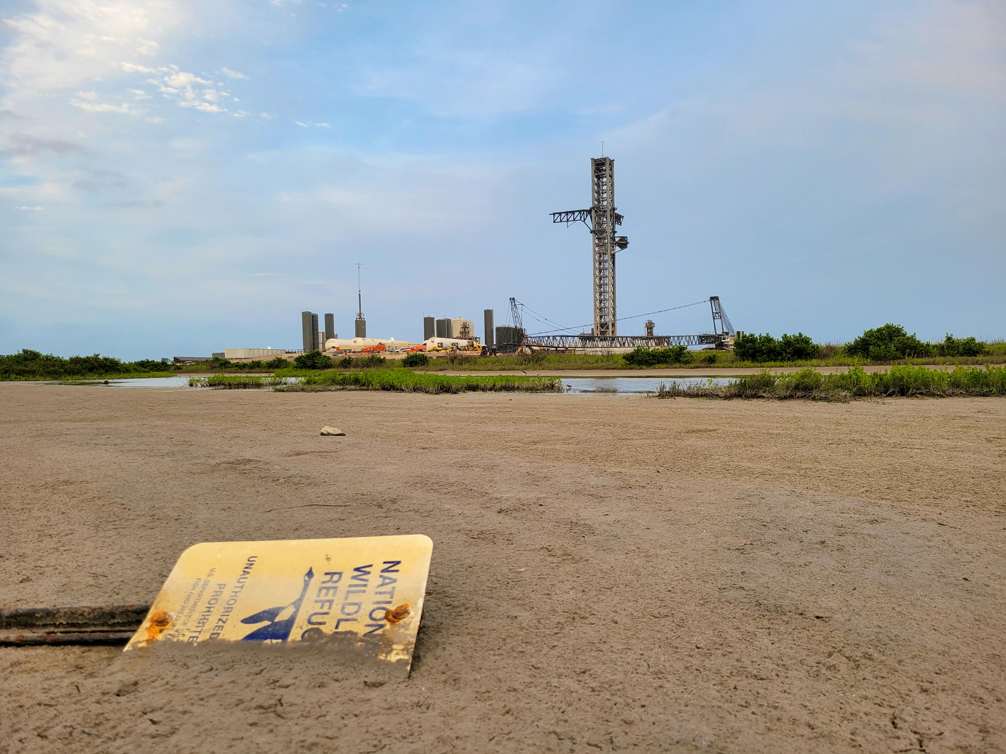 National Wildlife Refuge sign fallen over and buried in ground near SpaceX site where 2023 Starship explosion happened