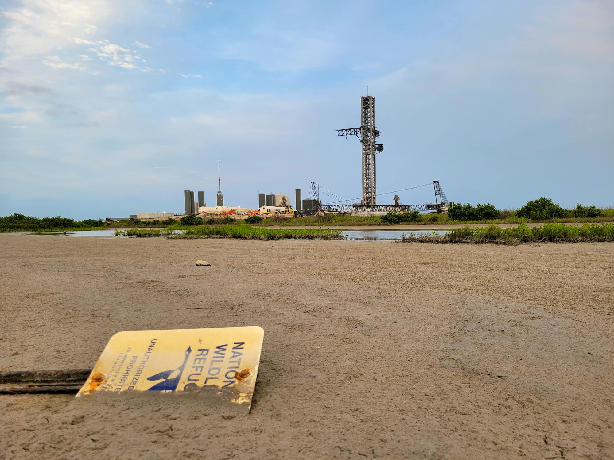 National Wildlife Refuge sign fallen over and buried in ground near SpaceX site where 2023 Starship explosion happened