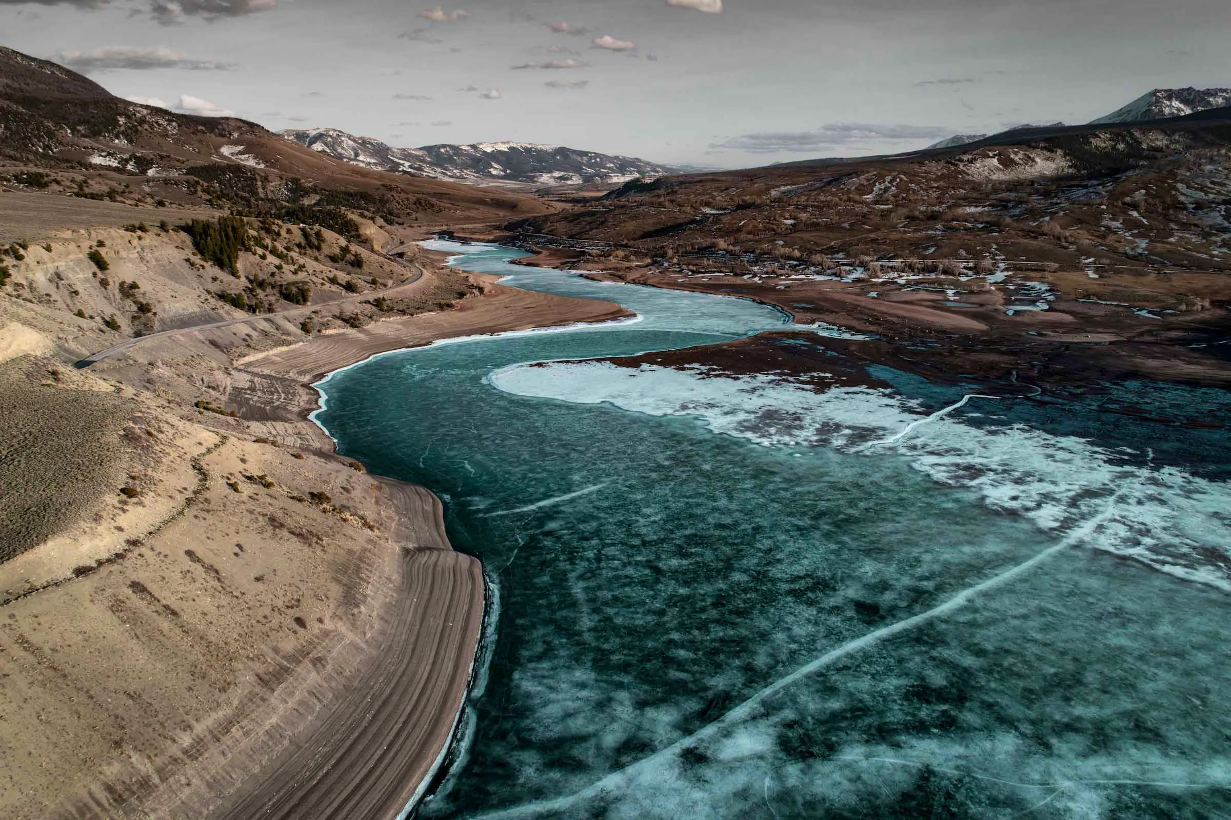 Body of water between mountains in Colorado, under a gray sky